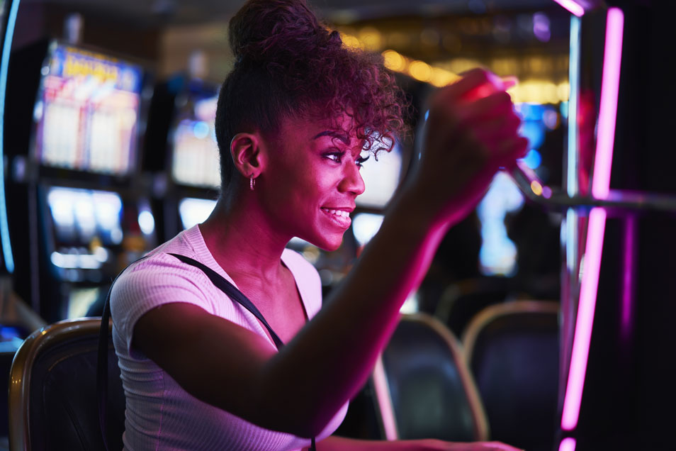 happy-woman-gambling-at-casino-playing-slot-machin- video slot machine - real action slots