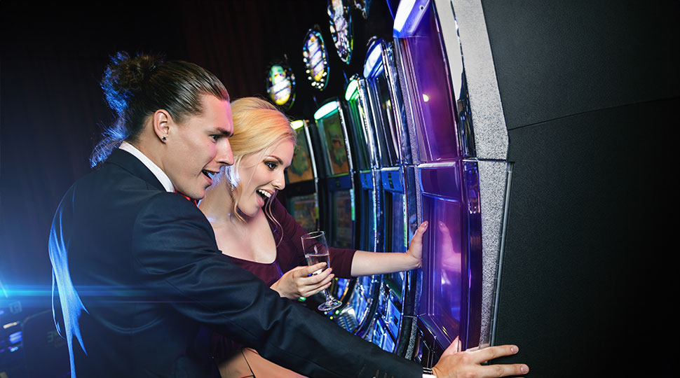casino tourism trends - couple playing slots - real action slots