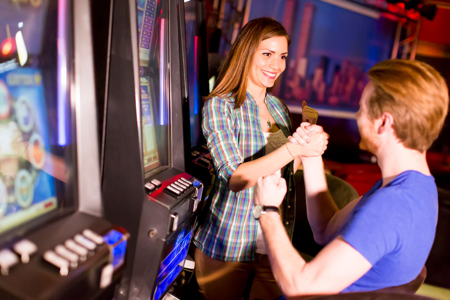 high-variability slot machines - happy winning couple playing slots - real action slots